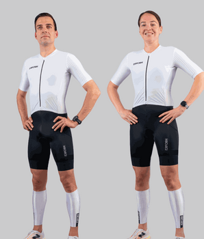 Male and female athletes wearing TechBoost FastSuit triathlon suits with white aero tops and black shorts against gray background