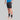 Man wearing black TechBoost Korte Tight shorts for running, paired with black socks and white running shoes.