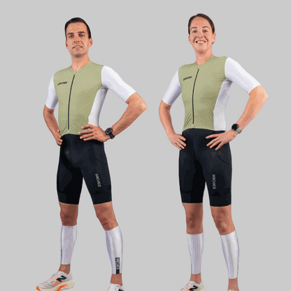 Men and women wearing sage and white Techboost FastSuit triathlon suits with aerodynamic design and black shorts