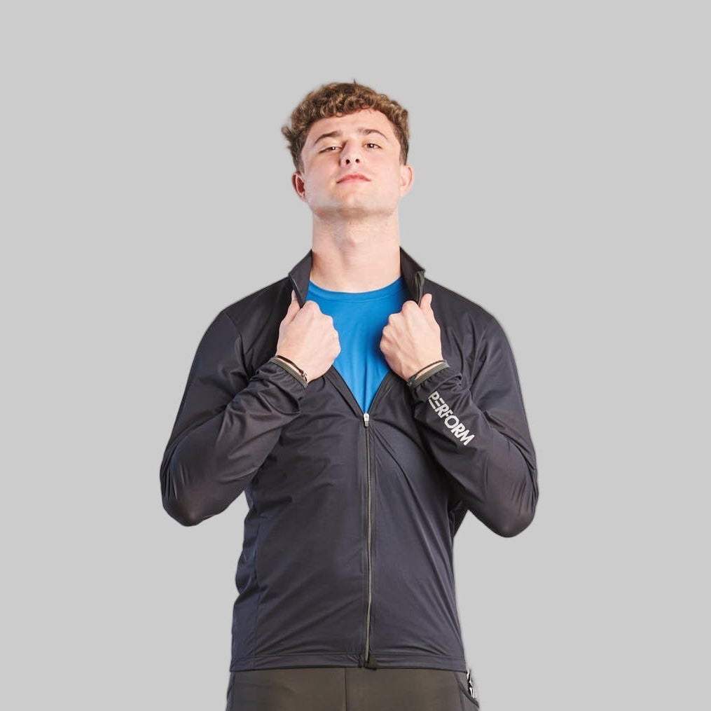 Man wearing black TechBoost Running Jacket for men, lightweight, wind and water-resistant with breathable fabric