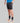 Man wearing black TechBoost Korte Tight shorts for running, paired with black socks and white running shoes.